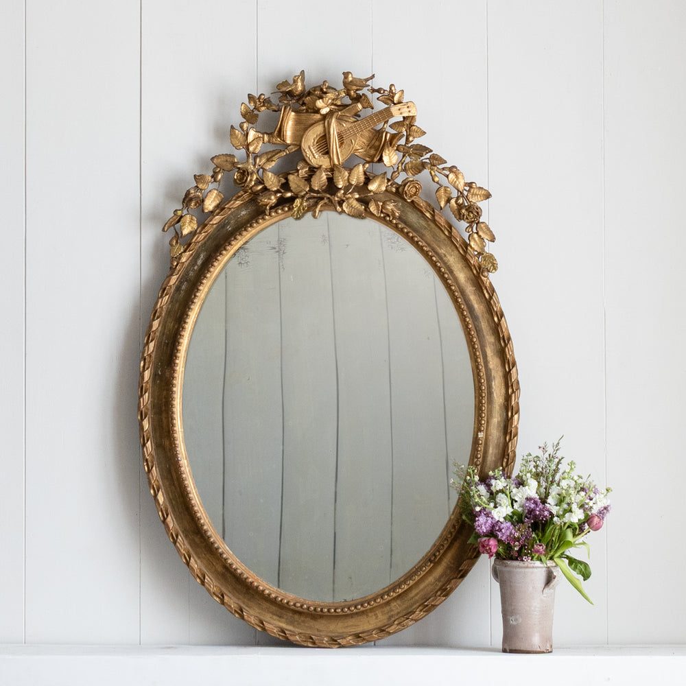 Antique Oval Gilt Mirror with Musical and Floral Fine Details